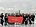 Karas So team holding Karas So LLP banner