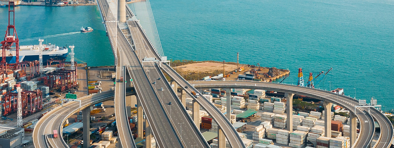 a bridge over water with a city in the background