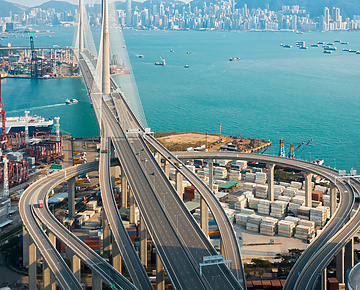 a bridge over water with a city in the background