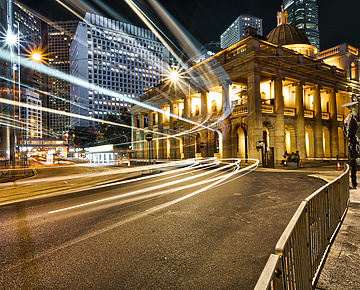 a street with lights and a building in the background